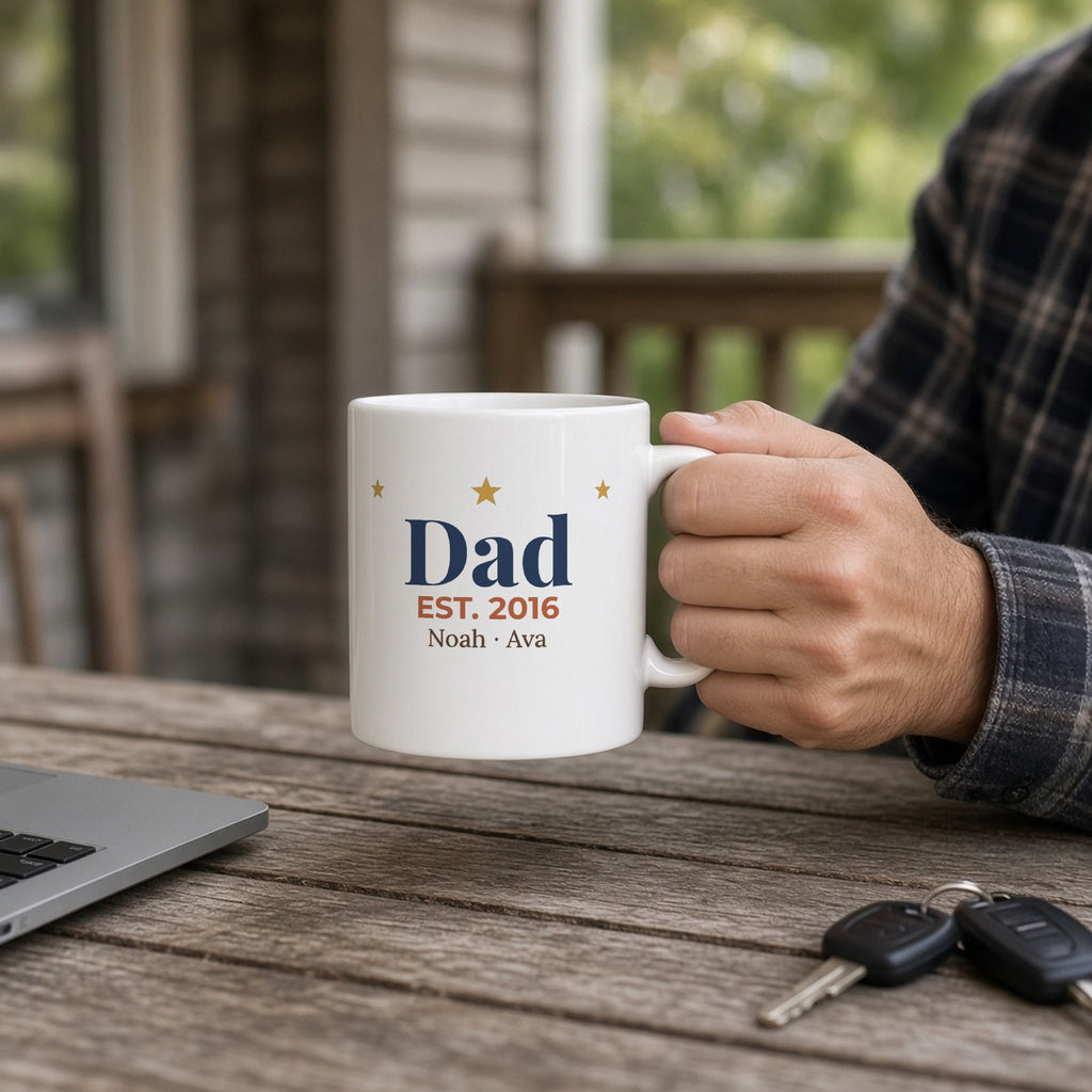 Personalized Dad Est. Year 11oz mug on a porch table — lifestyle photo with the real print design. Shown with sample names.