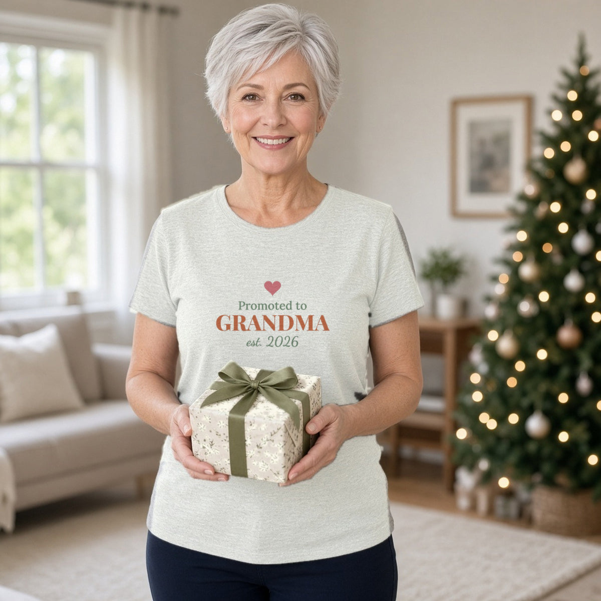 Promoted to Grandma t-shirt (Ash) worn at home at Christmas — lifestyle photo with the real print design